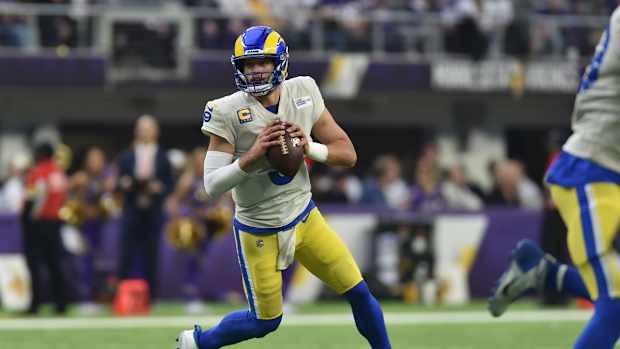 Dec 26, 2021; Minneapolis, Minnesota, USA; Los Angeles Rams quarterback Matthew Stafford (9) rolls out to throw a pass against the Minnesota Vikings during the second quarter at U.S. Bank Stadium. Mandatory Credit: Jeffrey Becker-USA TODAY Sports